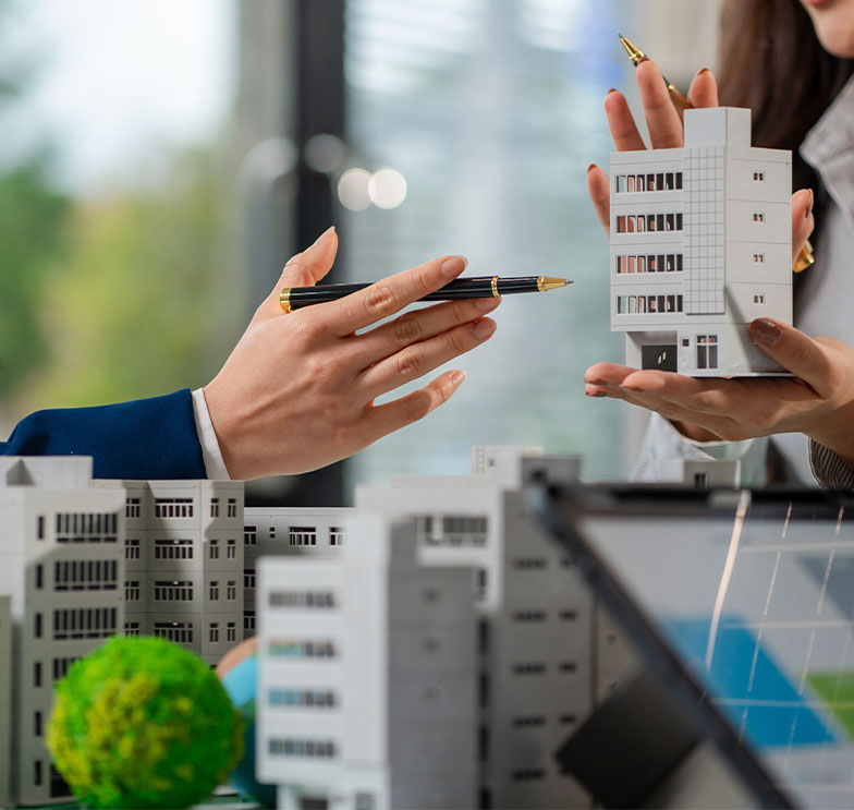 profissionais-realizam-estudo-de-mercado-imobiliario-e-due-diligence-analisando-maquetes-de-um-empreendimento